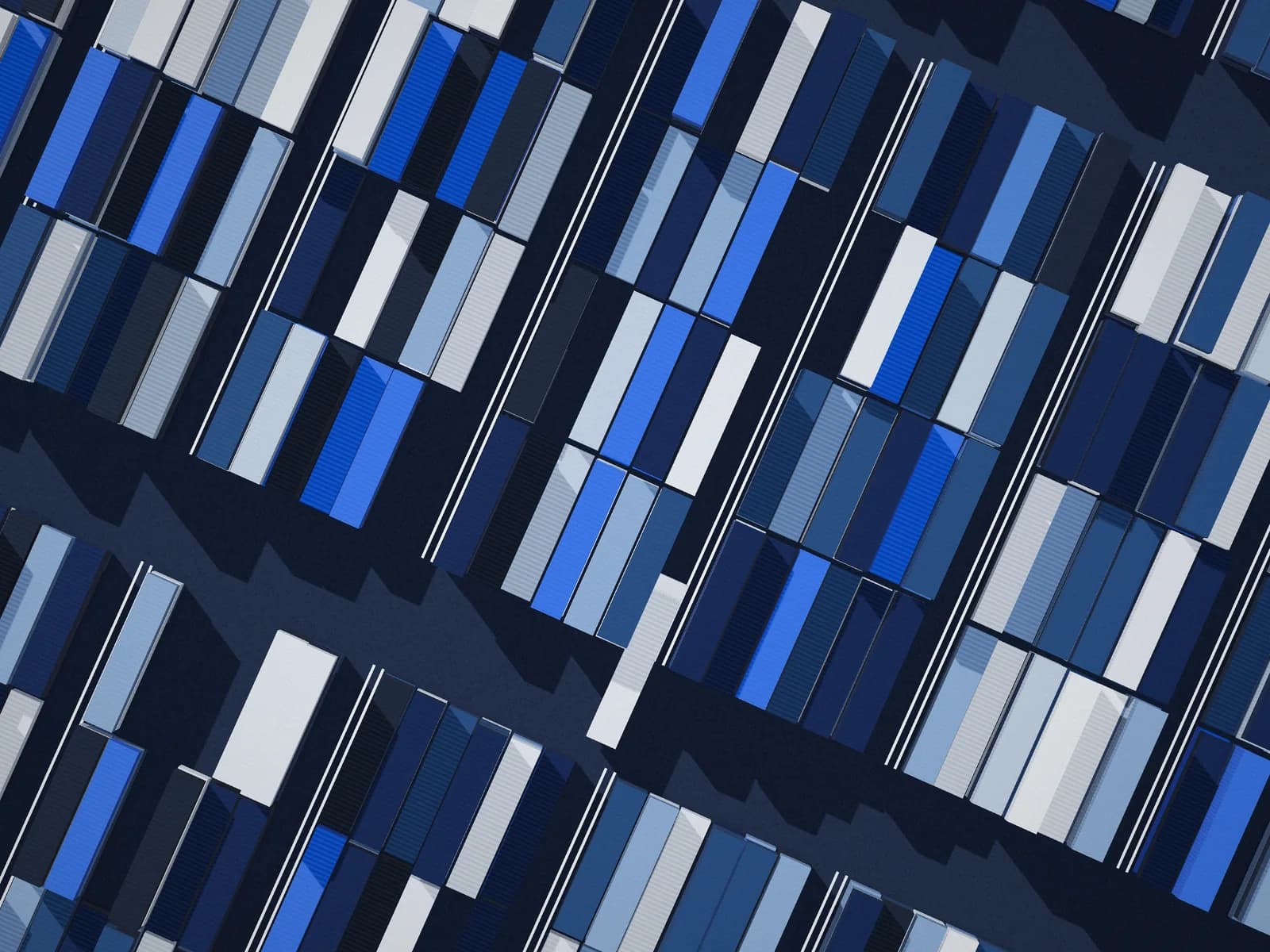 Aerial view of shipping containers stacked in rows at a cargo terminal